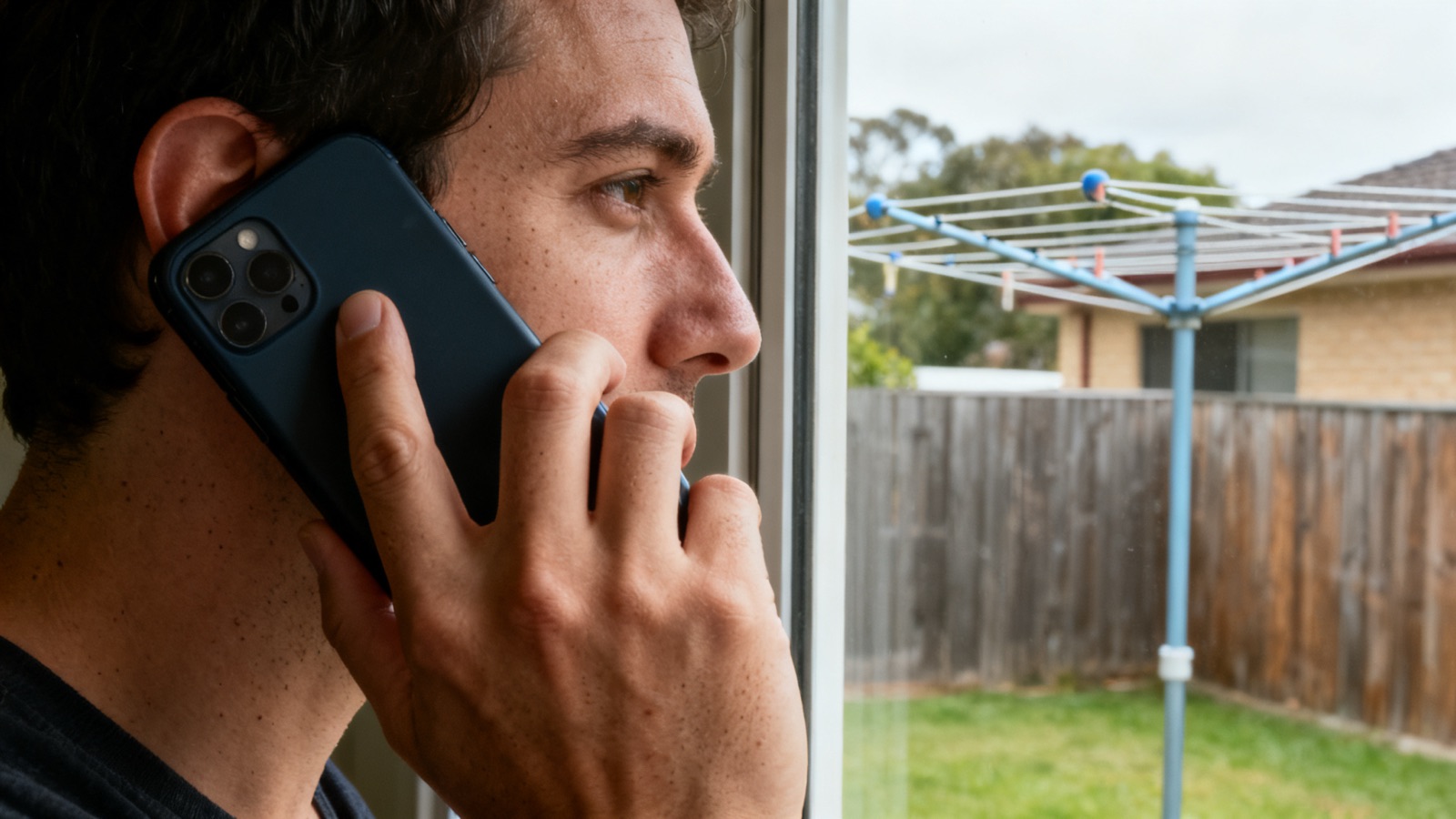 Tradie taking a phone call in an Australian backyard
